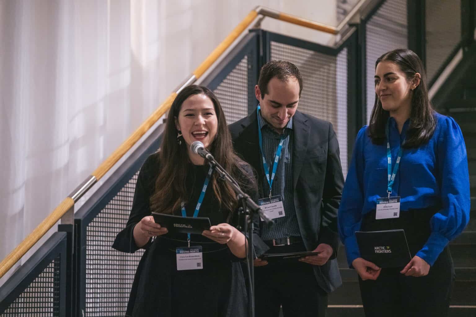 Image shows Emerging Leader speaking in front of a microphone at Exhibition opening.