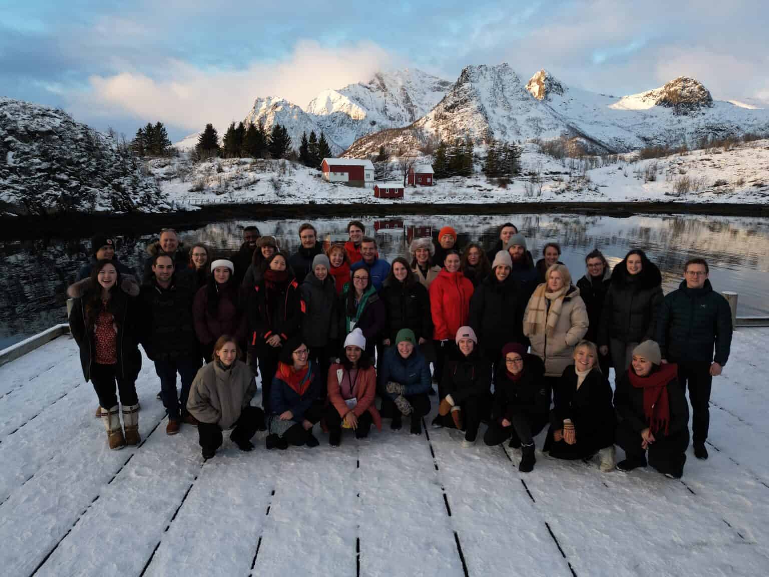 Image shows the 30 participants of Emerging Leaders 2023 in front of some mountains covered in snow. 