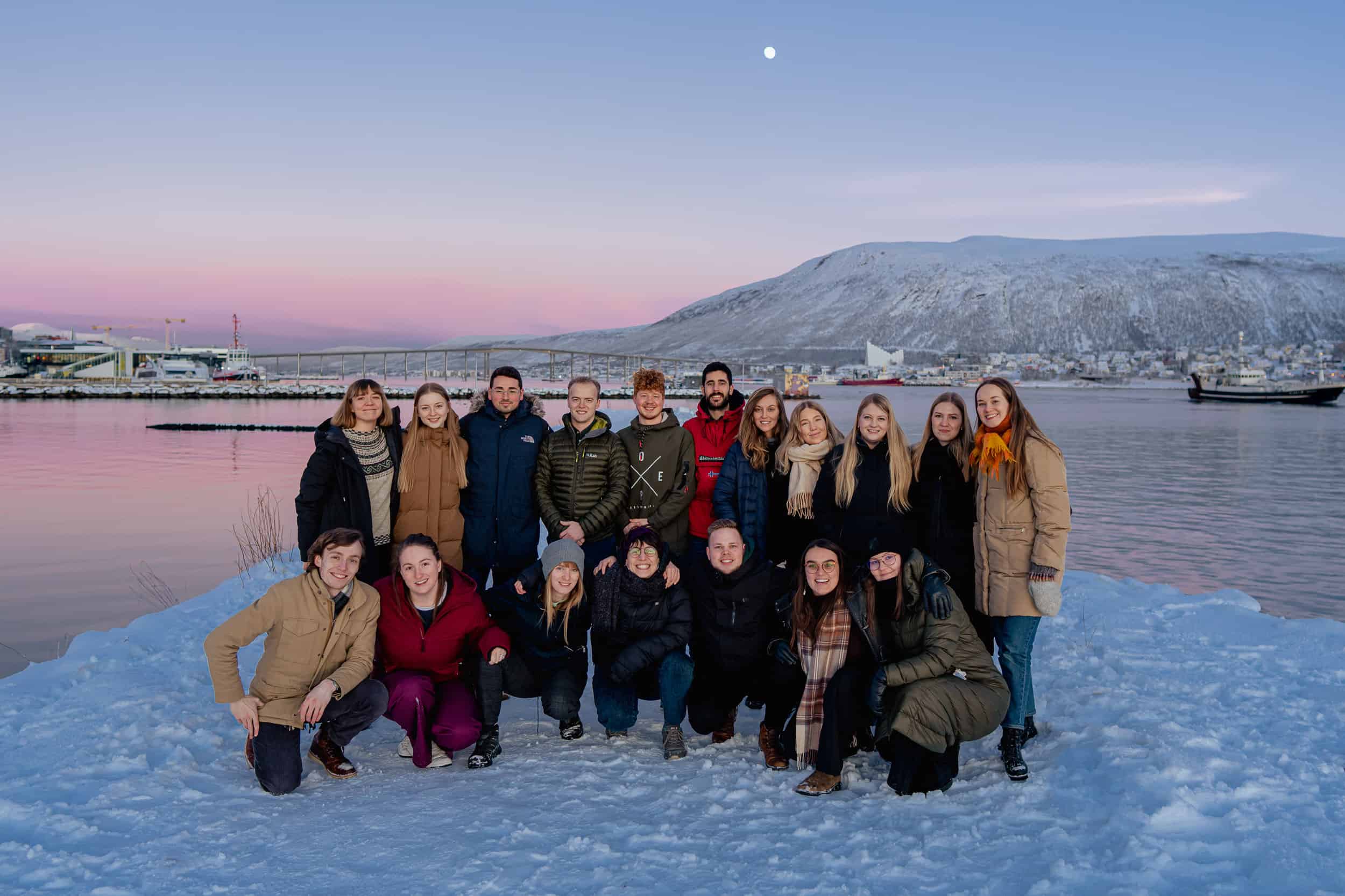 Image shows the 15 Student Forum 2023 participants in front of a winter scenery in Tromsø. 