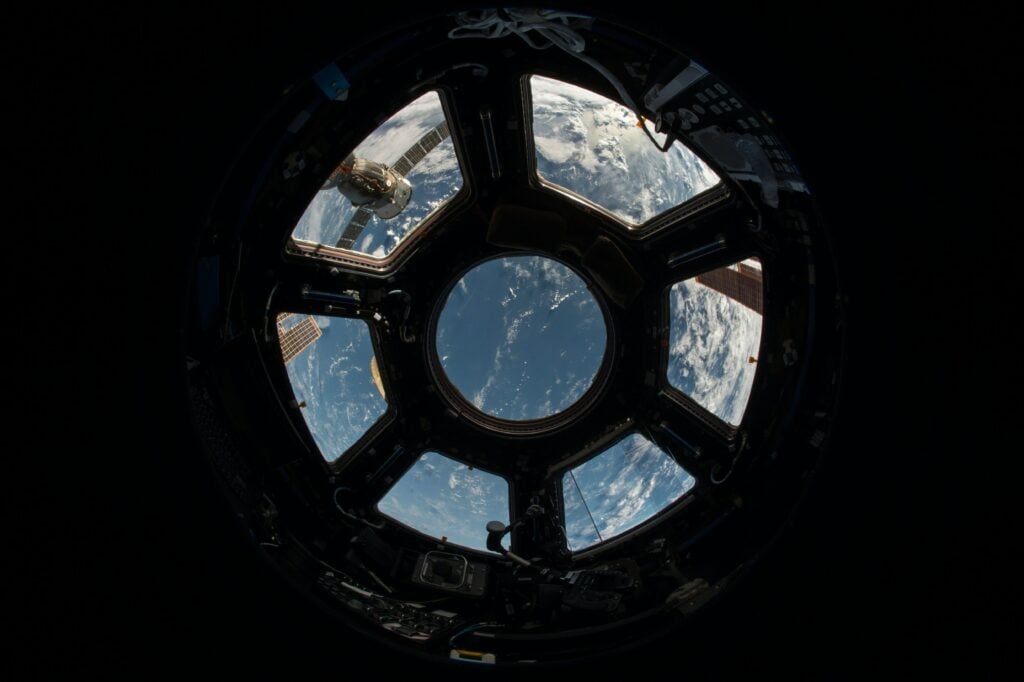 Photo shows image of earth from inside a satellite.