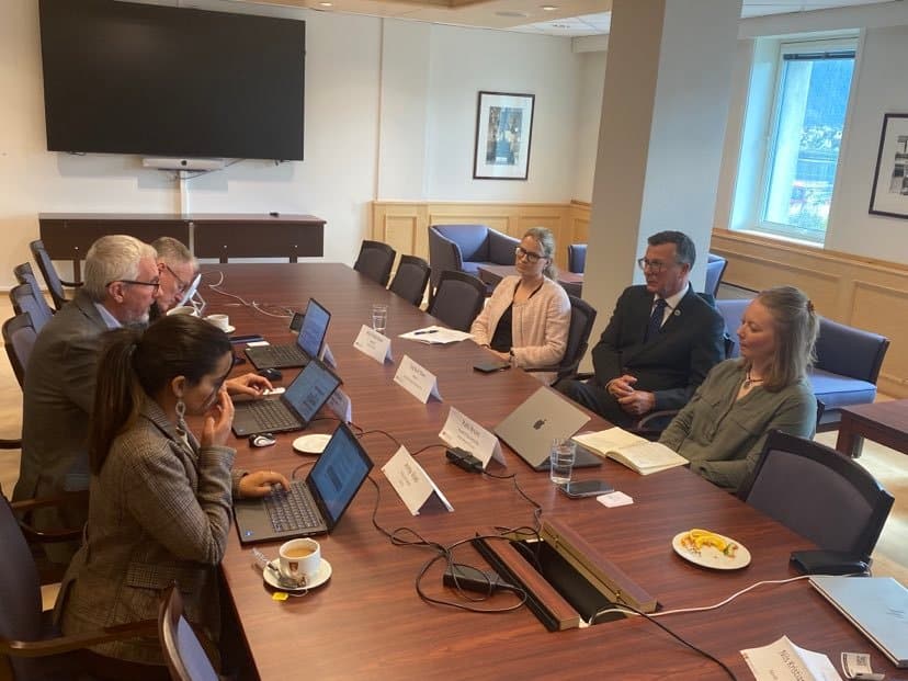 Image shows six people sit around a big table engaging in a a discussion. Image includes Executive Director of Arctic Frontiers, Anu Fredrikson. 