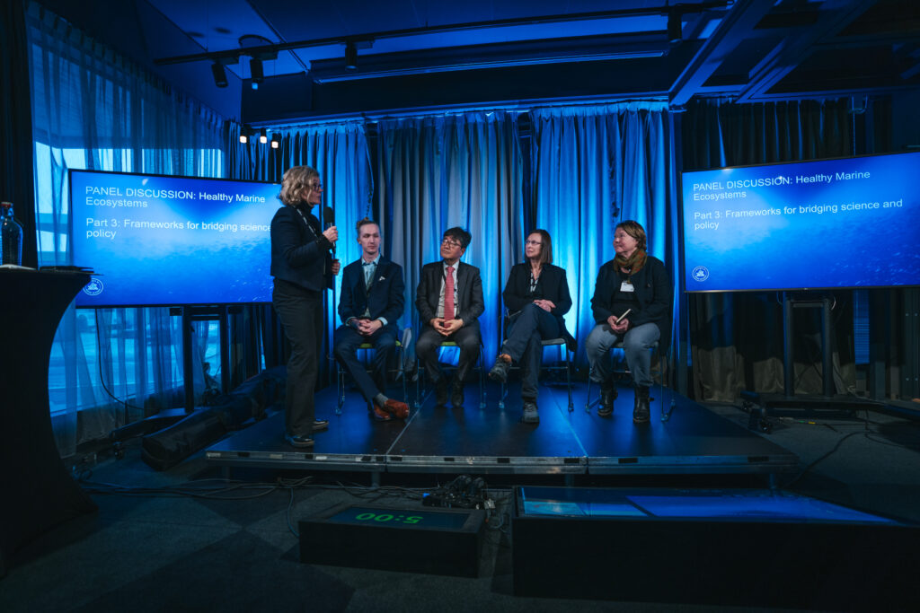A panel of scientists discuss a presentation on stage