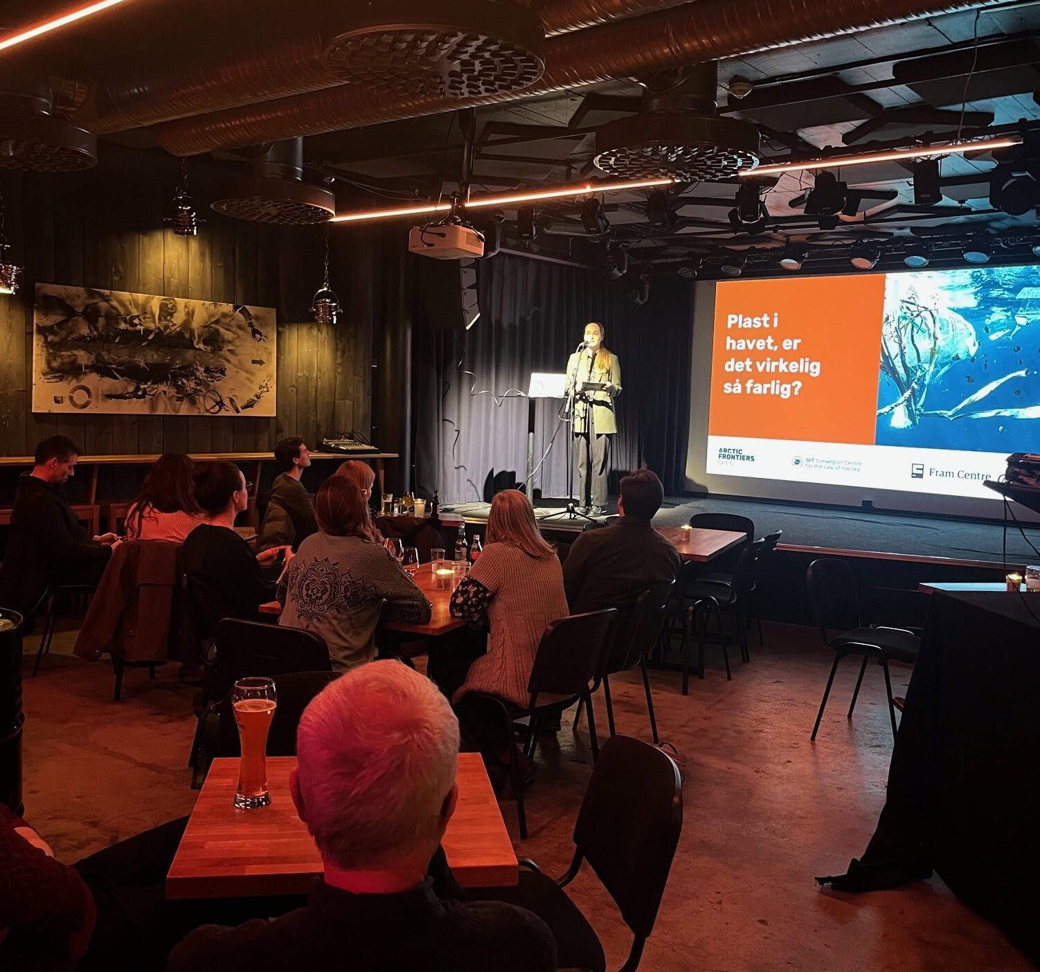 image shows audience and person on stage