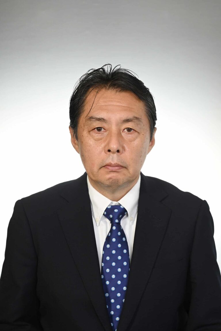 Arctic Frontiers - A man in a suit and blue polka dot tie poses for a formal portrait against a plain light background.