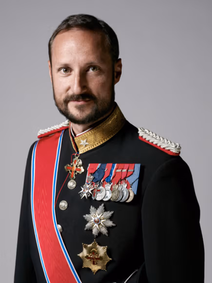 Arctic Frontiers - A man in a formal military uniform with medals, decorations, and a red sash, posing against a plain background.