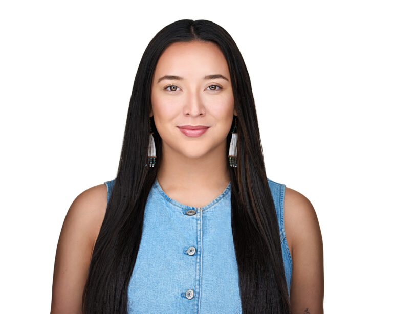 Arctic Frontiers - Portrait of a woman with long dark hair wearing a denim waistcoat, embodying Arctic resilience.